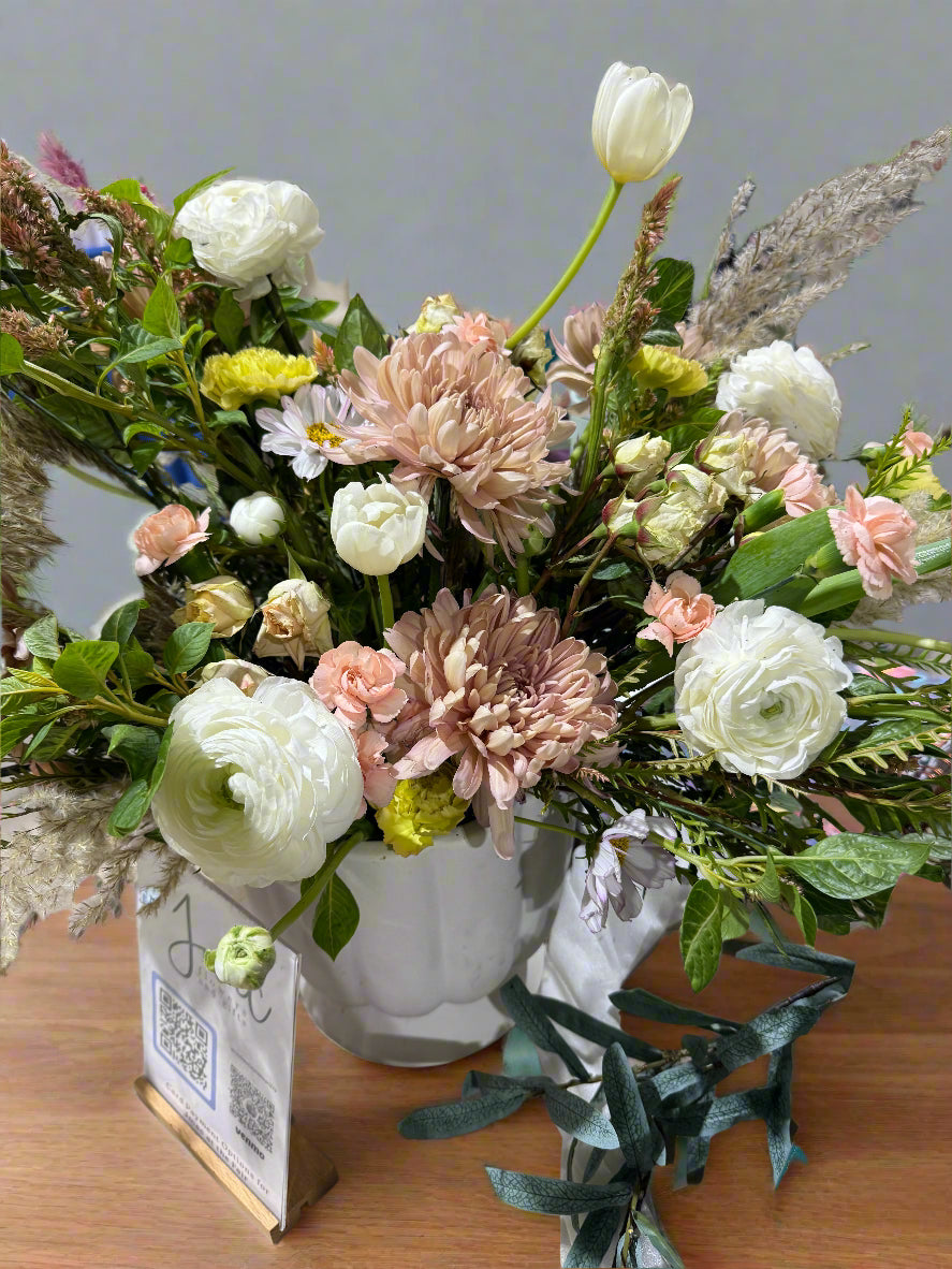 Bouquet of flowers with a decorative box on a wooden surface