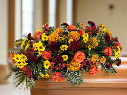 Colorful floral arrangement on a wooden casket